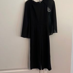 Black jumpsuit with cape sleeves